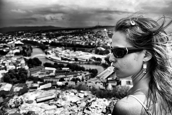 A beautiful woman stands atop Narikala Fortress in Tbilisi, Georgia