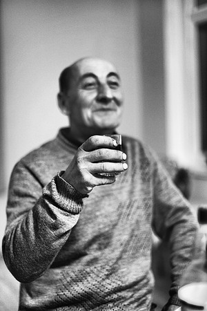 A man raises a wine glass to make a toast